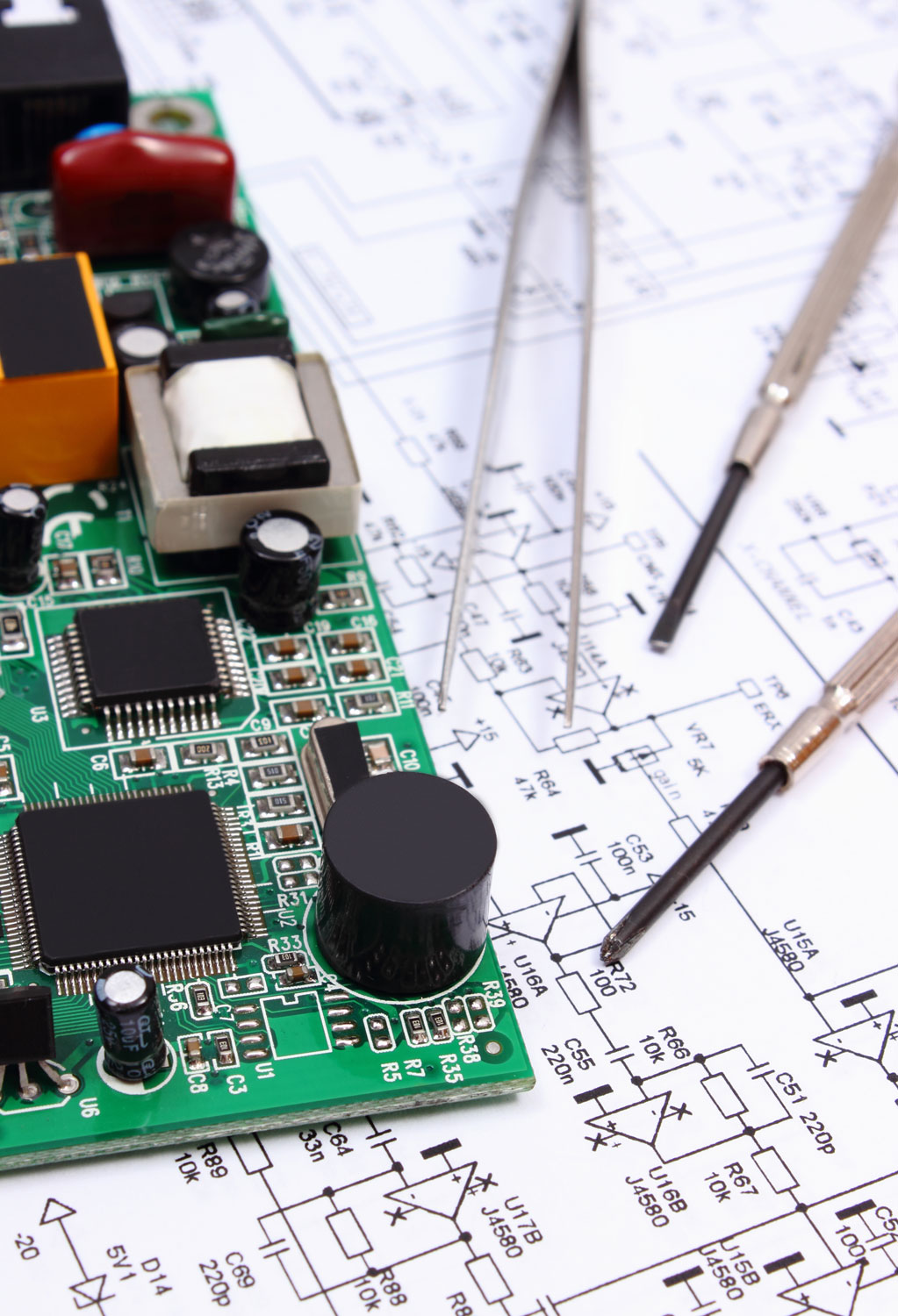 Printed circuit board and precision tools on diagram of electronics
